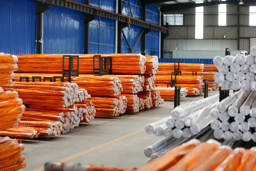 Warehouse area filled with professionally packaged stainless steel pipes on organized racks, demonstrating systematic storage and inventory management.