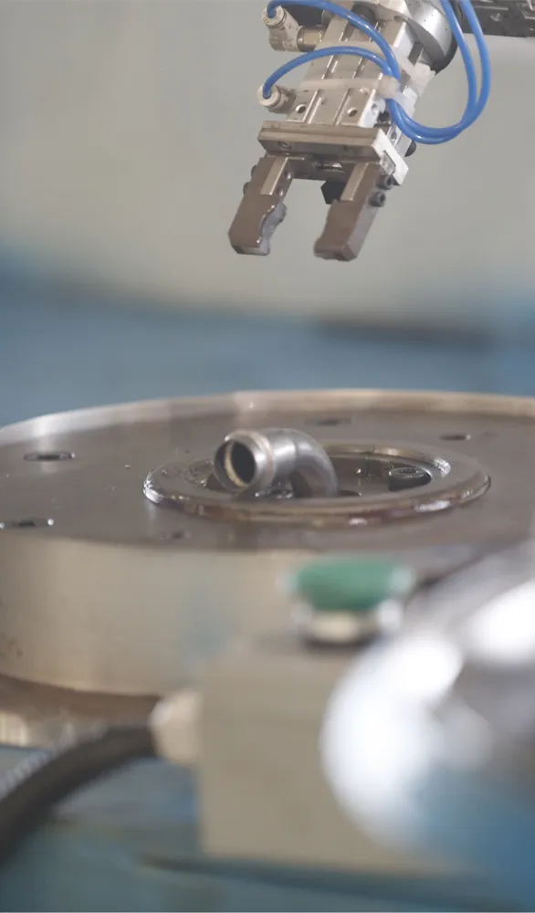 An automated machining center actively manufacturing a batch of stainless steel press-fit fittings in Nonleak's facility, demonstrating high-precision, consistent production.