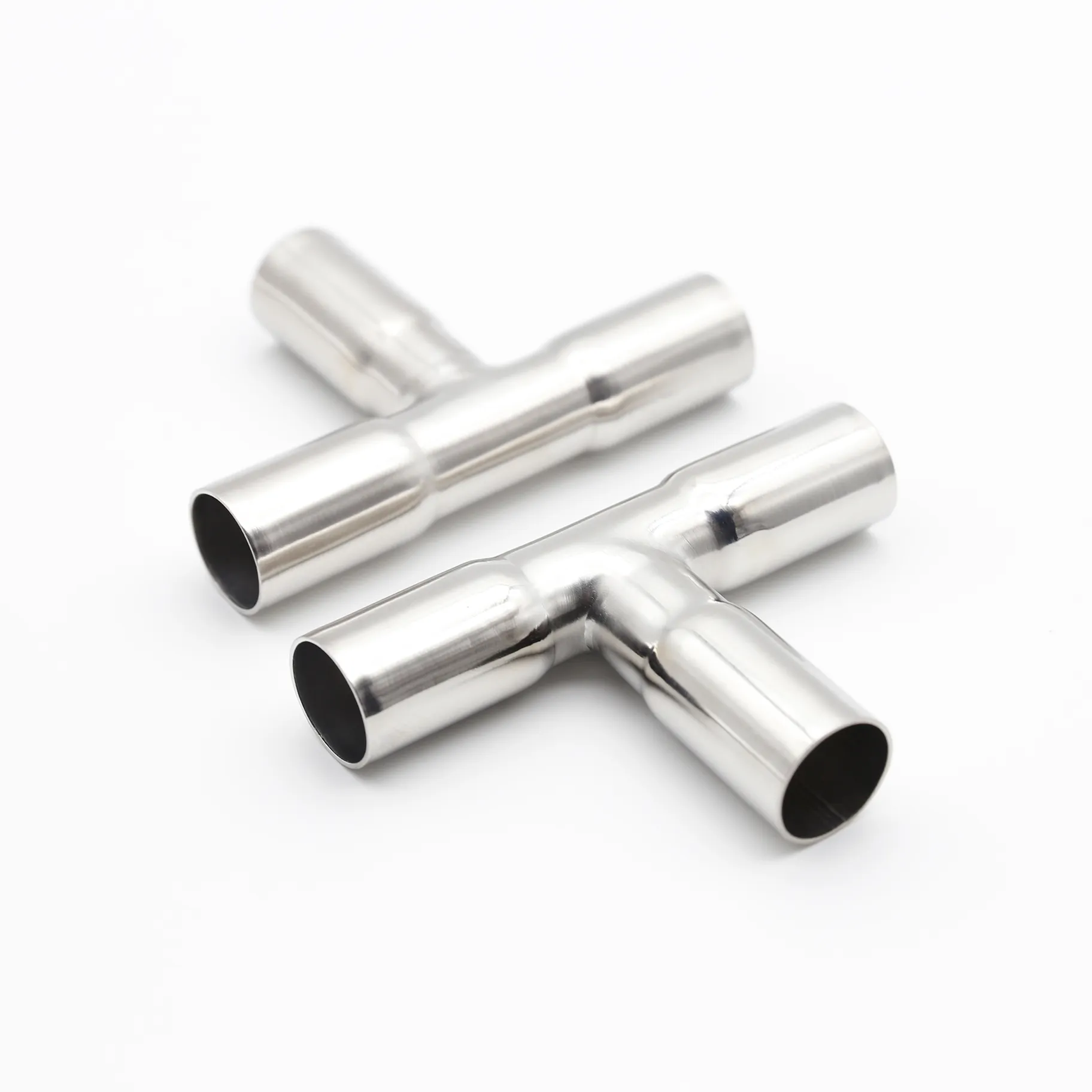 Two stainless steel equal tees displayed together showing manufacturing consistency