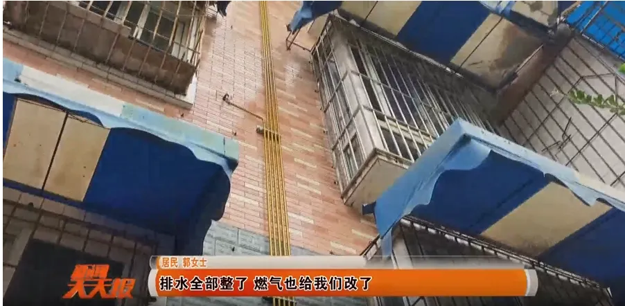 A network of new stainless steel gas pipes routed horizontally along a building wall, with secure brackets.