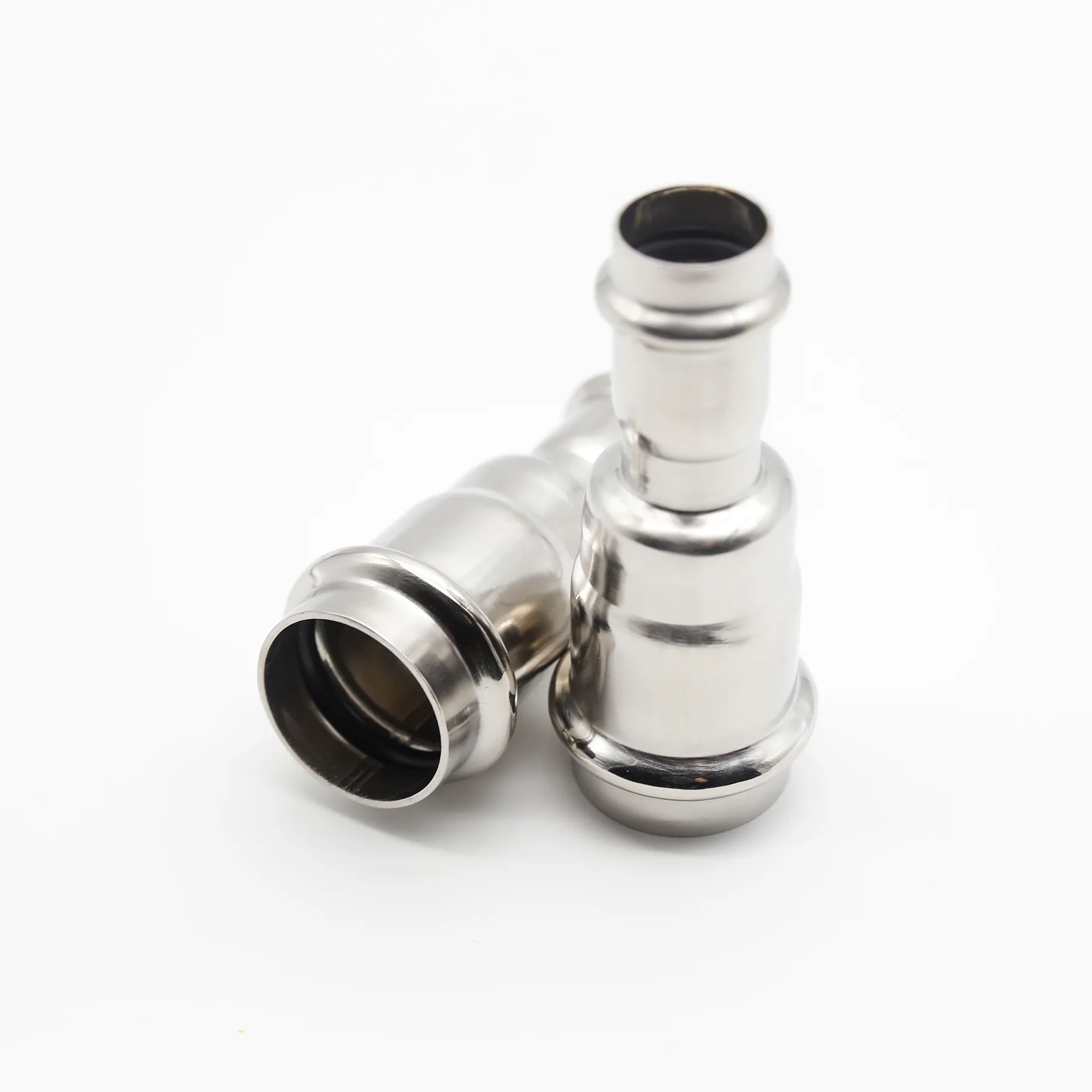 Two identical stainless steel reducing couplings placed side-by-side on a white background.
