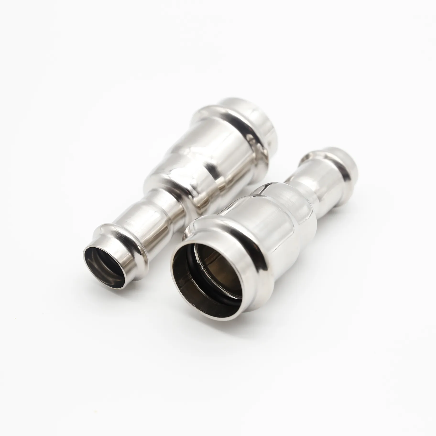 Two reducing couplings positioned at staggered angles, suggesting their use in a pipeline.