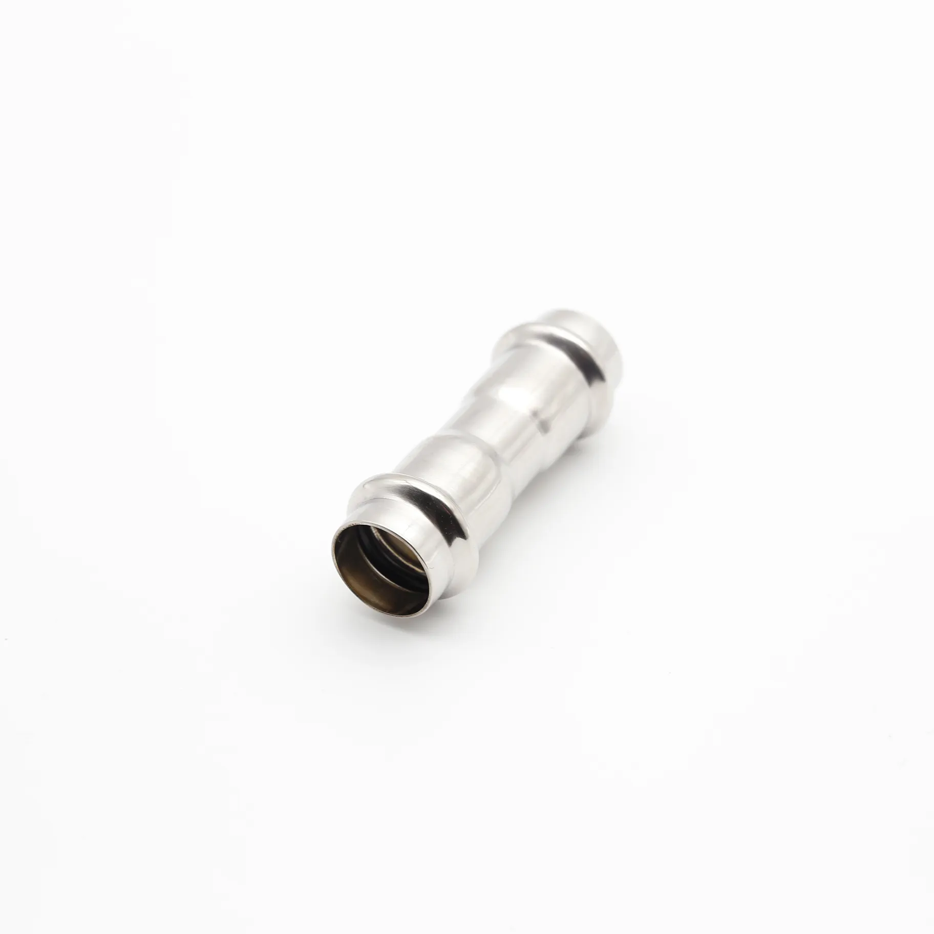 Three-quarter angle view of a stainless steel straight press-fit coupling isolated on a white background.