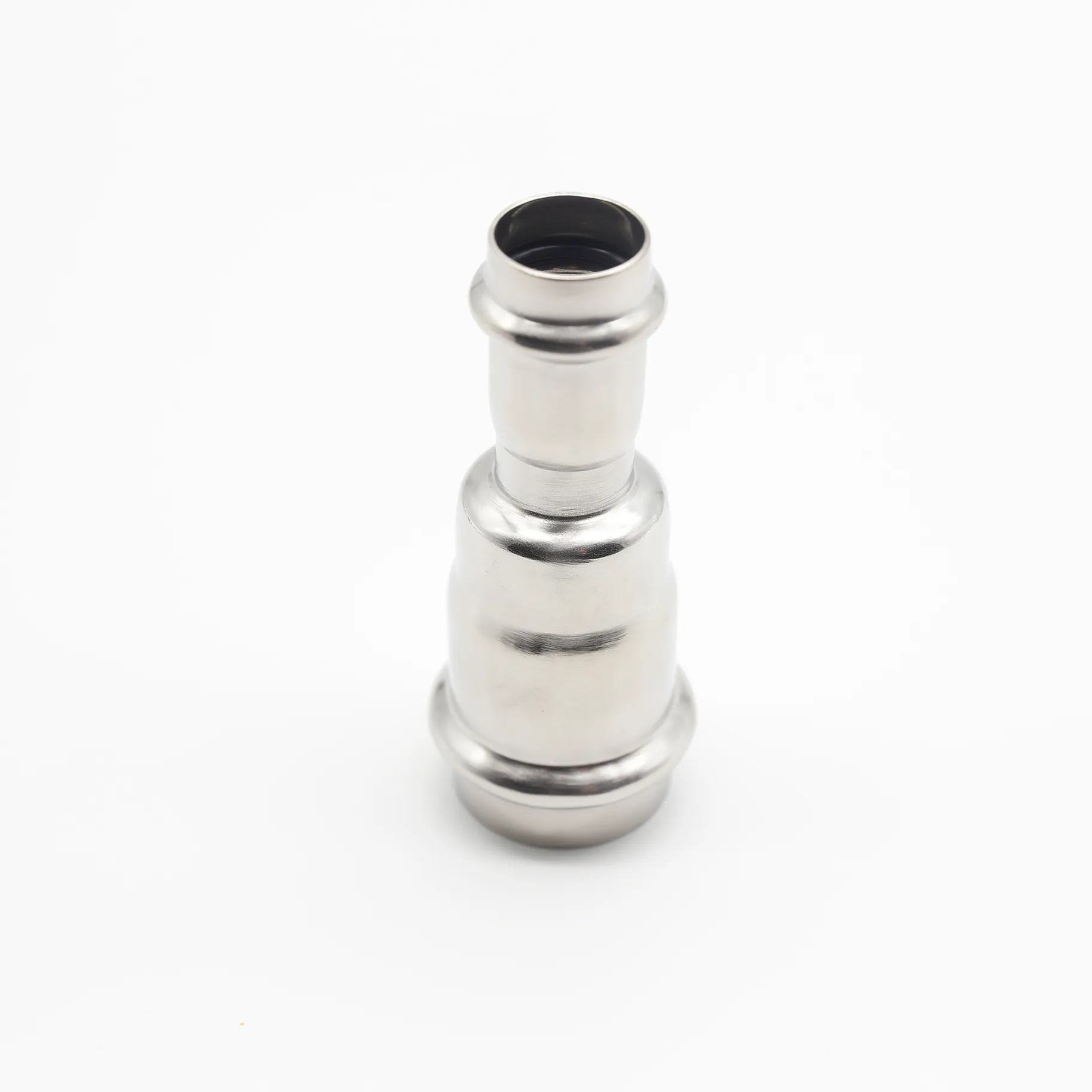 Stainless steel reducing coupling for press-fit piping systems