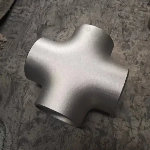 Three-quarter angle view of a stainless steel four-way equal cross fitting isolated on white background, showing all four perpendicular ports